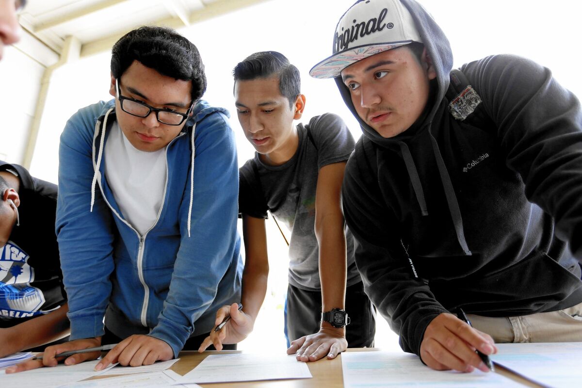 Jose Lizarraga, 18, left, Ivan De La Cueva, 18, and Julian Alvarez, 18, register to vote at Esteban Torres High School in Los Angeles, part of the citywide #LAYouthVote campaign sponsored by the United Way.