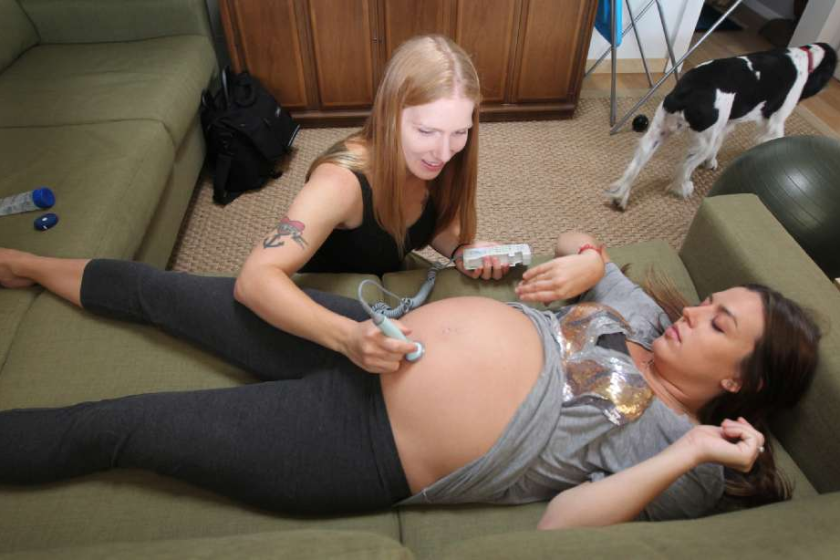 Rebecca Prediletto, a licensed midwife, conducts a prenatal exam on Amy Terranova, who opted to deliver her baby at her Silverlake home.