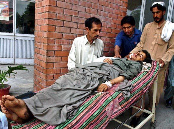 Relatives of a Pakistani victim of a U.S. airstrike shift him to a hospital room after treatment in Peshawar. Eleven Pakistani troops were killed in the airstrike near the Afghan border, in an incident that Islamabad said could jeopardize cooperation in the fight against terrorism.