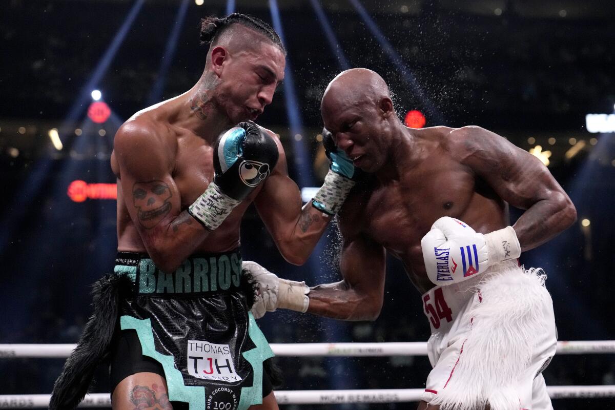 Mario Barrios, left, fights Yordenis Ugas in Las Vegas in September.