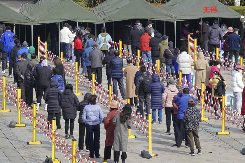 Residents line up for COVID-19 test in Yantai city in eastern China's Shandong province Monday, March 14, 2022. China's new COVID-19 cases Tuesday more than doubled from the previous day as the country faces by far its biggest outbreak since the early days of the pandemic. (Chinatopix via AP)