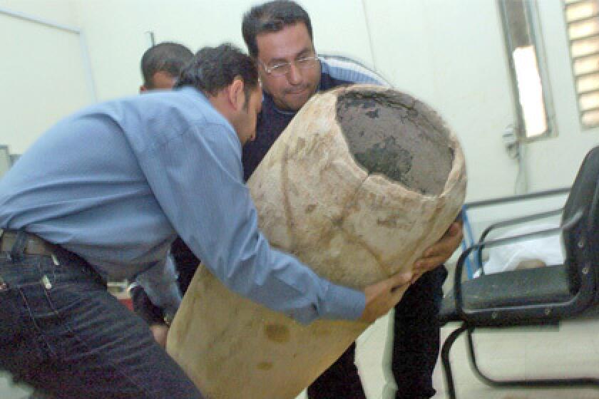 Officials at Iraq's National Museum receive recently recovered artifacts.