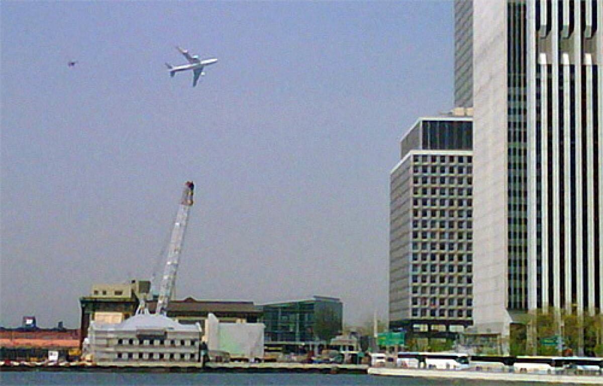 In this image taken with a cell phone by Jason McLane, a Boeing 747 flies low over New York Harbor, followed by an F-16 chase plane during a federal government photo opportunity.
