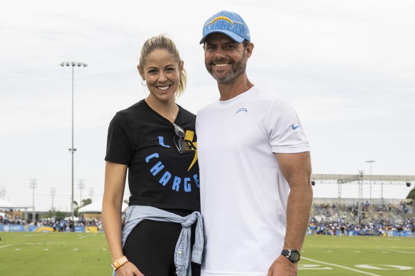 Costa Mesa, CA - July 29: Los Angeles Chargers head coach Brandon Staley, right, and his wife Amy pose for a photo.