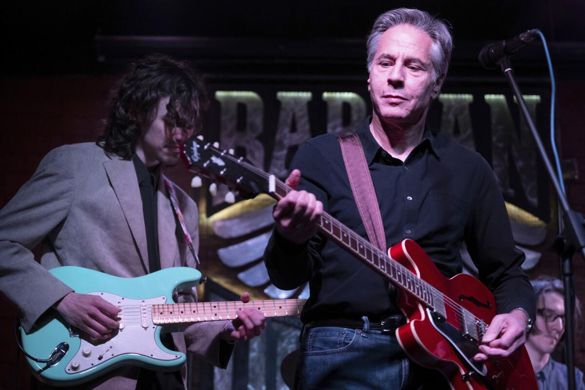 Secretary of State Antony Blinken plays guitar in a Kyiv bar.