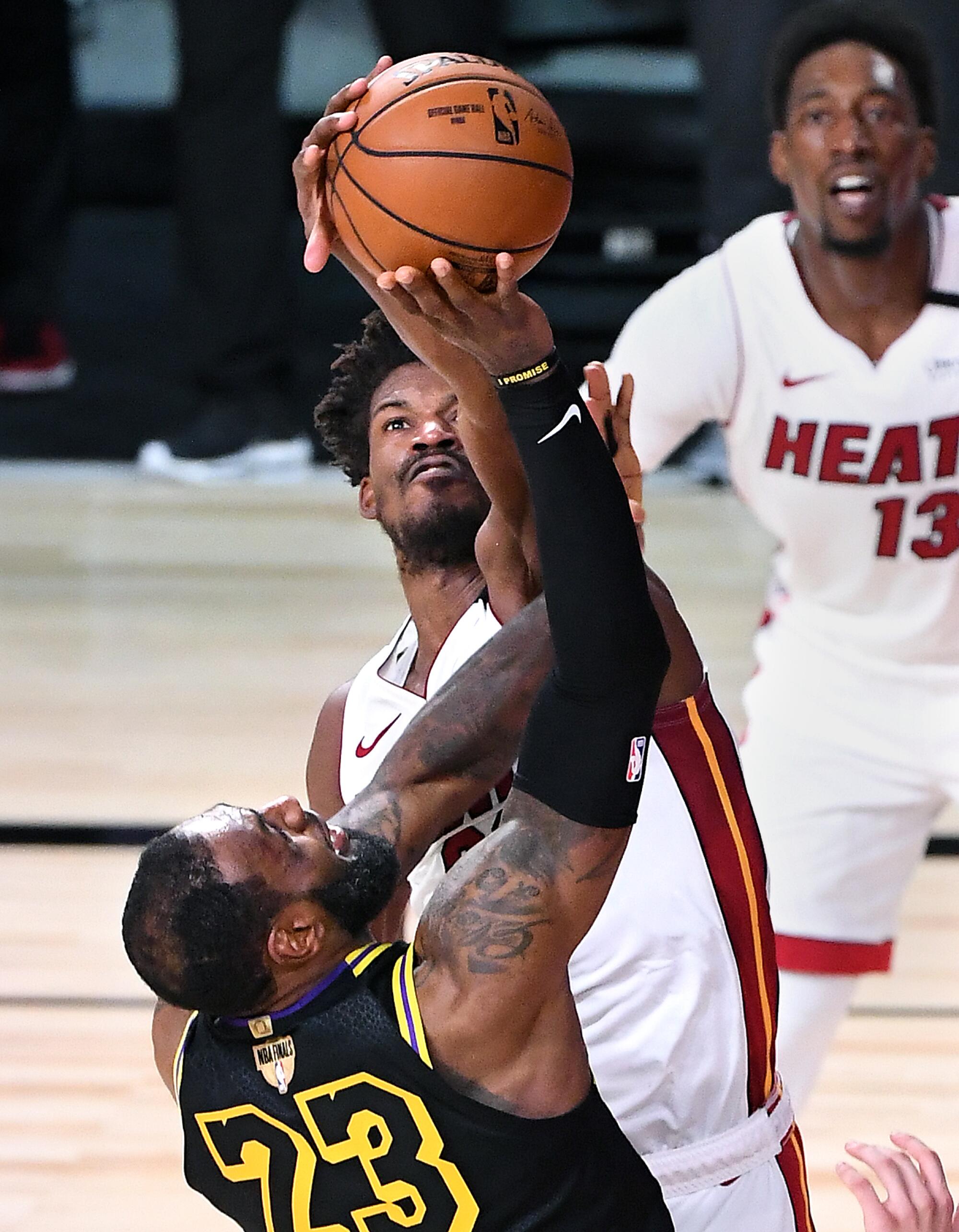 Miami Heat forward Jimmy Butler blocks a shot by Lakers forward LeBron James during Game 5 of the NBA Finals on Friday.