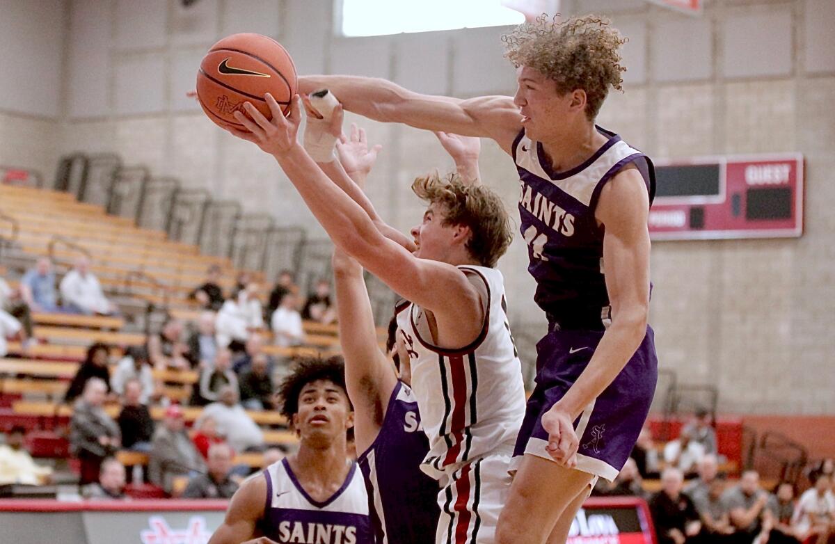 JSerra forward Korin Hull’s shot is blocked from behind by St. Augustine’s Isaiah Hasten during the Nike Extravaganza.