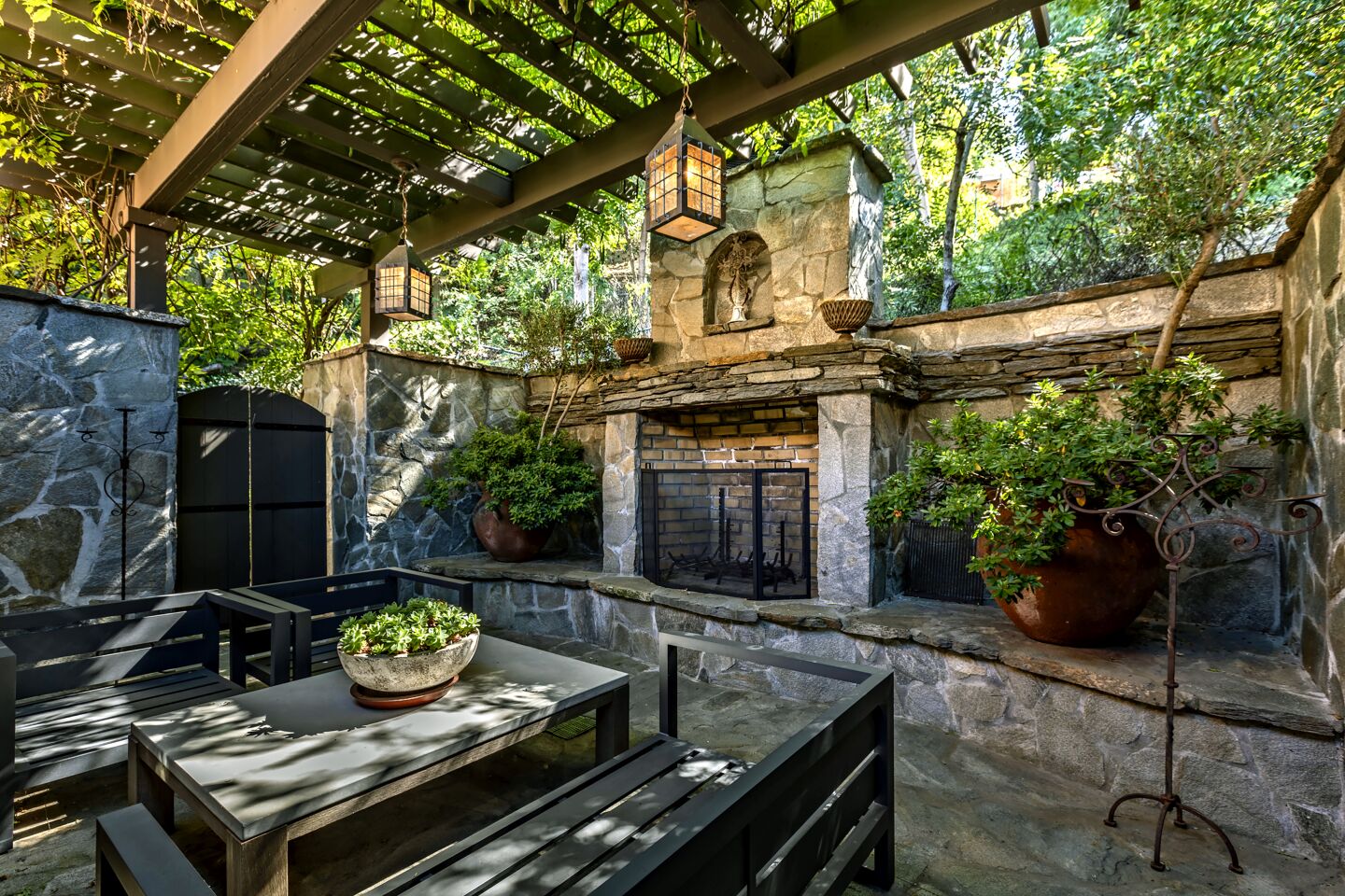 The courtyard is dominated by a brick-and-stone fireplace.
