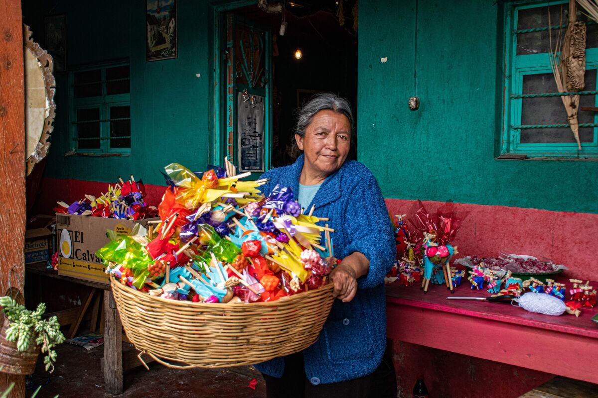 Teresa Molina Diaz on 15 June 2022 holds a basket with dozens of corn husk mules