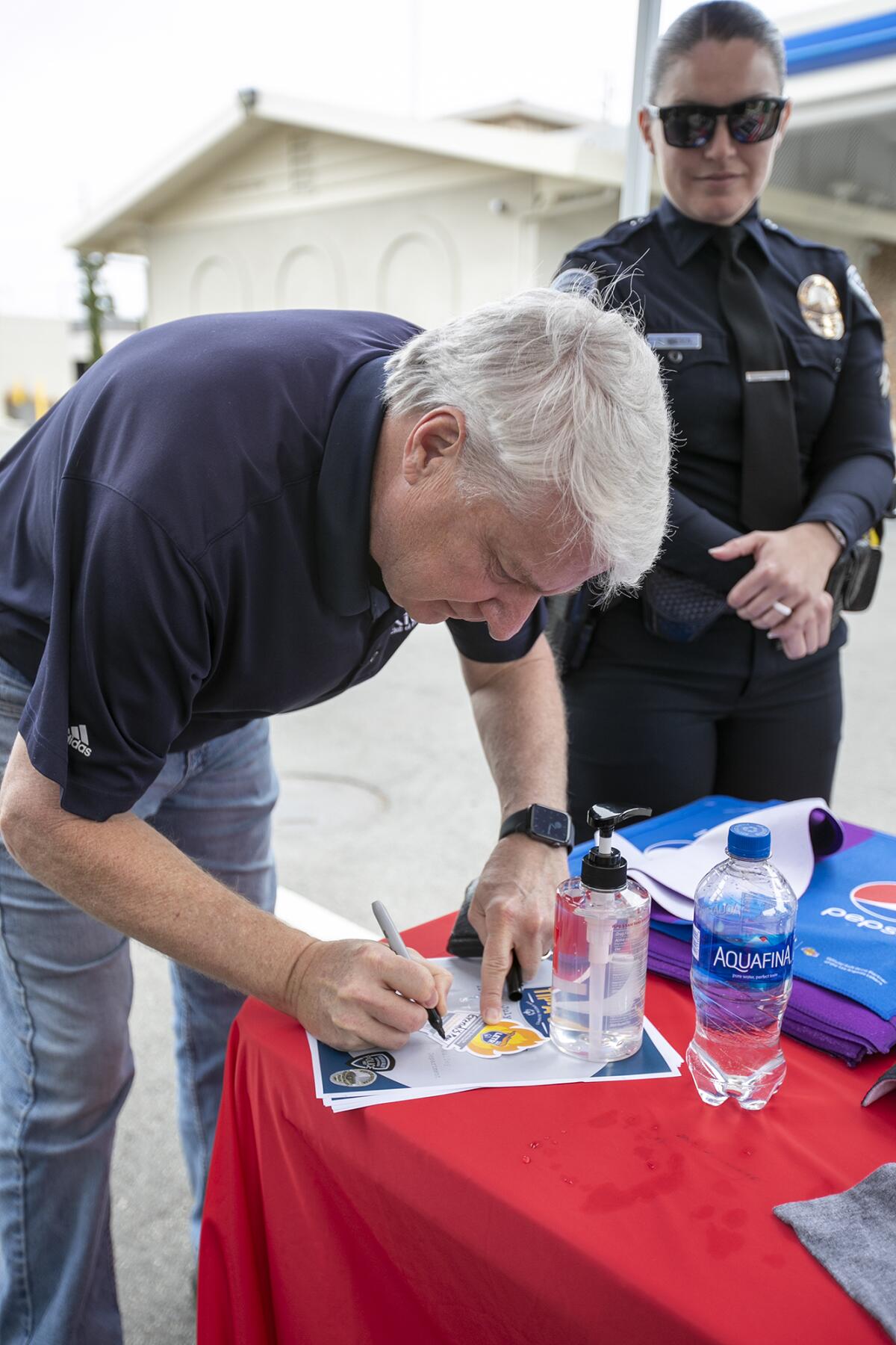 Fountain Valley Mayor Pro Tem Glenn Grandis makes a donation to the Special Olympics Thursday outside an Arco station.