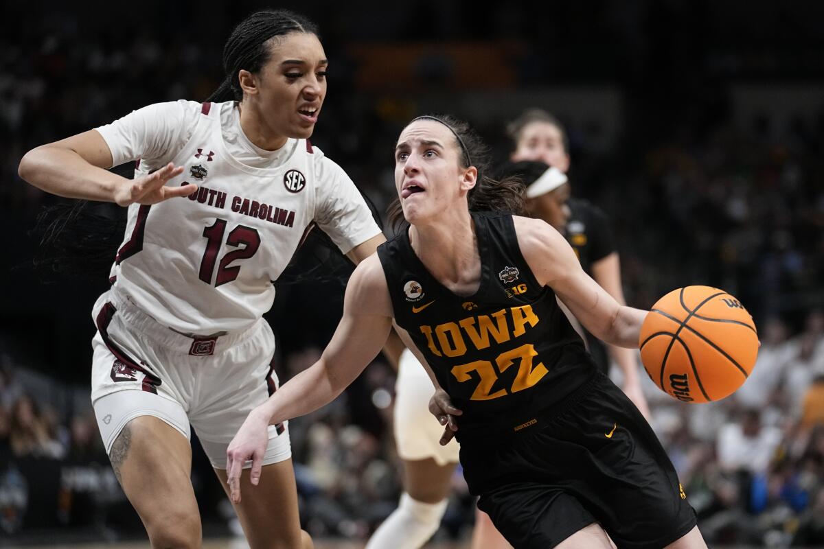 Iowa's Caitlin Clark drives past South Carolina's Brea Beal during the second half.
