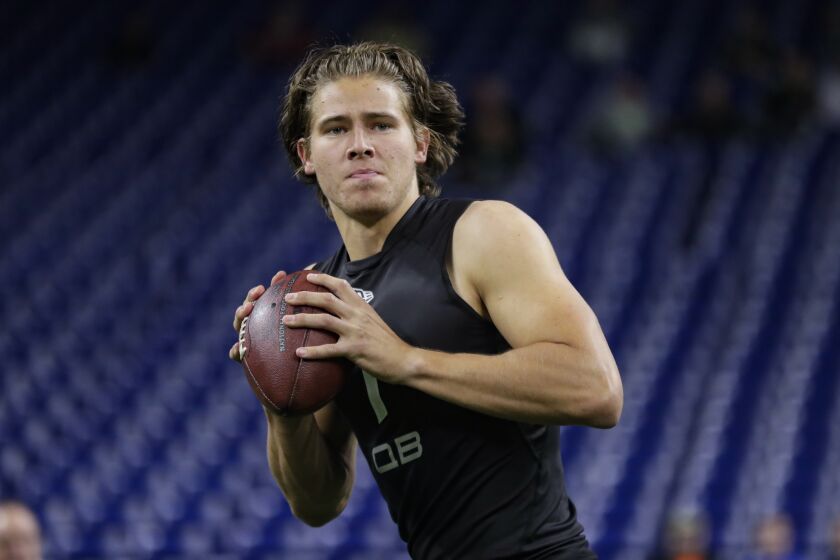 FILE - In this Feb. 27, 2020, file photo, Oregon quarterback Justin Herbert runs a drill at the NFL football scouting combine in Indianapolis. Herbert is a likely first-round pick in the NFL draft Thursday, April 23, 2020. (AP Photo/Michael Conroy, File)