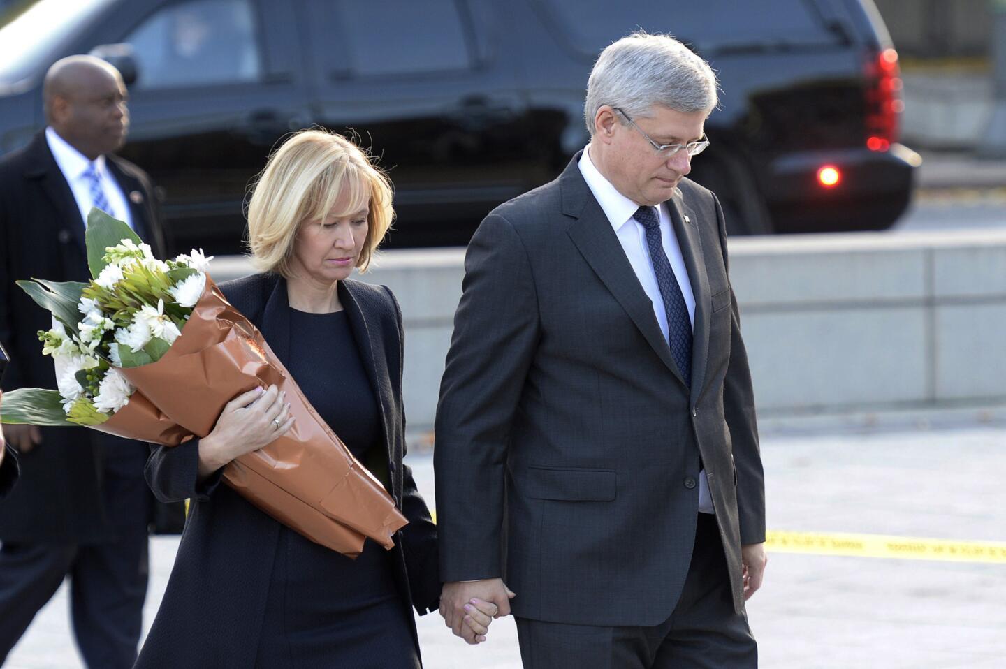 Prime Minister Stephen Harper and his wife, Laureen, visit Canada's Tomb of the Unknown Soldier in Ottawa on Oct. 23, the day after Cpl. Nathan Cirillo was killed by a gunman.