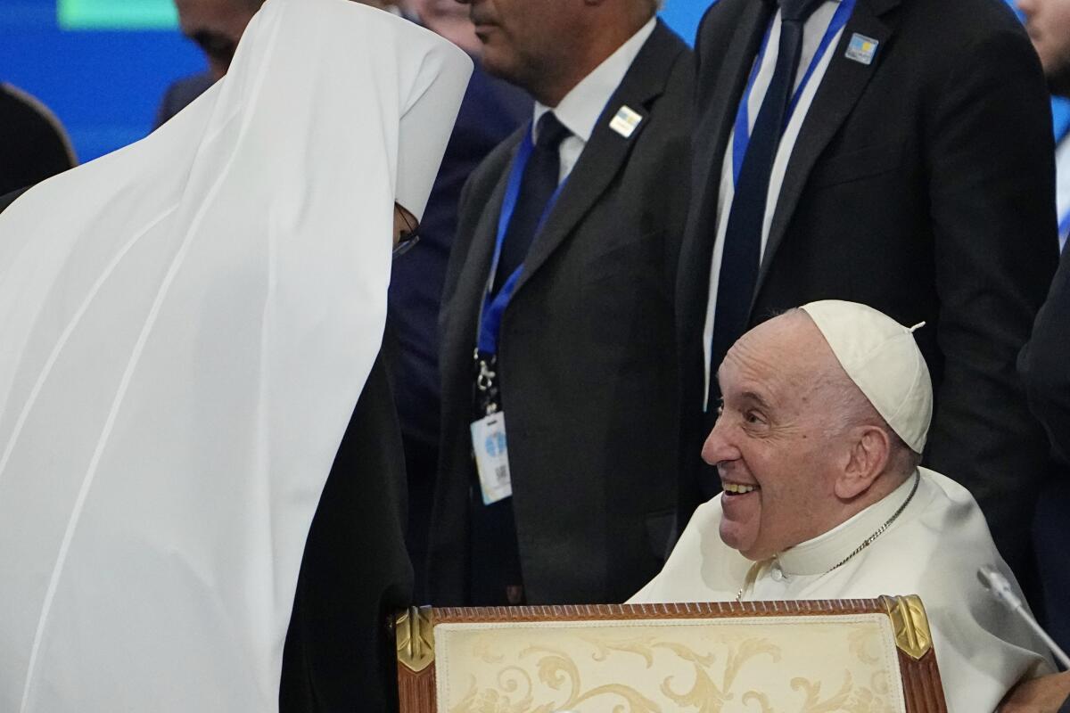 Pope Francis cheers with Metropolitan Antony at the end of the '7th Congress of Leaders of World and Traditional Religions, at the Palace of Peace and Reconciliation, in Nur-Sultan, Kazakhstan, Thursday, Sept.15, 2022. Pope Francis is on the third day of his three-day trip to Kazakhstan. (AP Photo/Alexander Zemlianichenko)