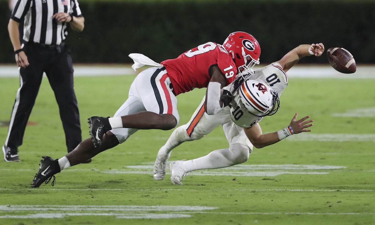 Georgia linebacker Adam Anderson levels Auburn quarterback Bo Nix, who was called for intentional grounding during the second half of an NCAA college football game Saturday, Oct. 3, 2020, in Athens, Ga. (Curtis Compton/Atlanta Journal-Constitution via AP)