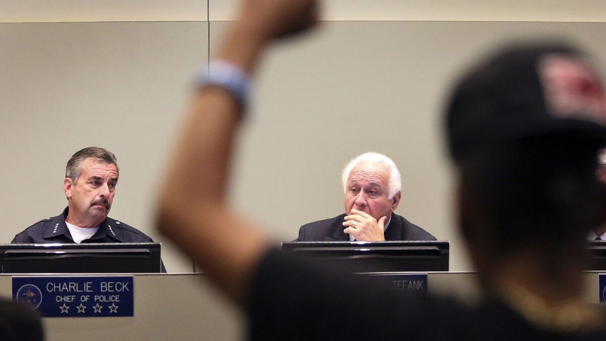 Beck and Police Commission Executive Director Richard Tefank, right, listen to Black Lives Matter leader Jasmine Richards during a June 2015 commission meeting.