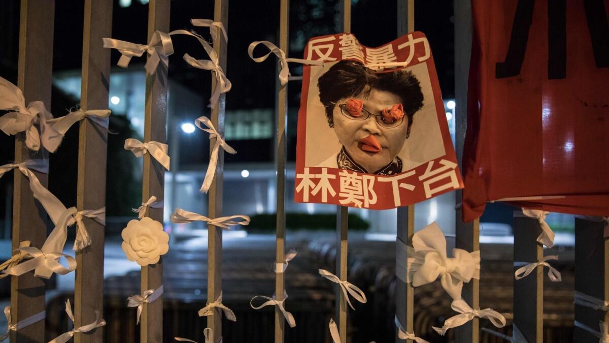 A poster bearing an image of Hong Kong Chief Executive Carrie Lam is displayed outside the government headquarters after a rally against an extradition bill Monday.