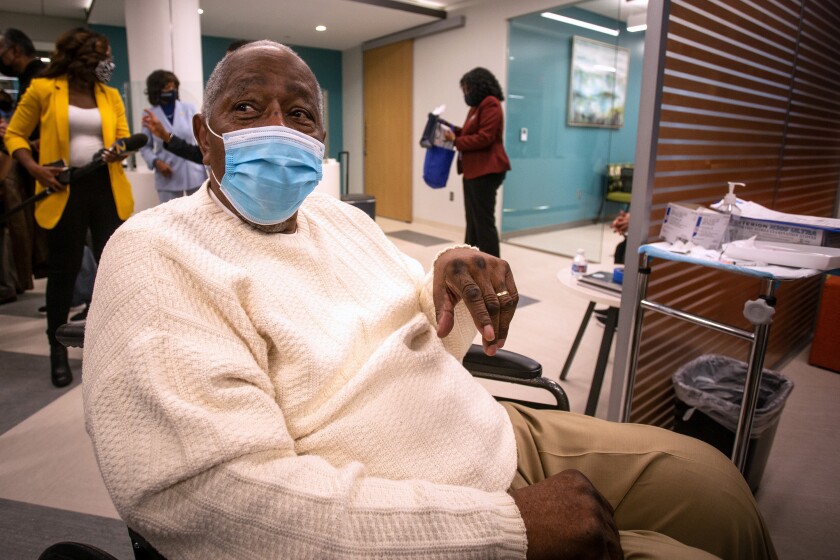 Baseball Hall of Famer Hank Aaron waits to receive his COVID-19 vaccination on Tuesday, Jan. 5, 2021, at the Morehouse School of Medicine in Atlanta. Aaron and others received their vaccinations in an effort to highlight the importance of getting vaccinated for Black Americans who might be hesitant to do so. (AP Photo/Ron Harris)