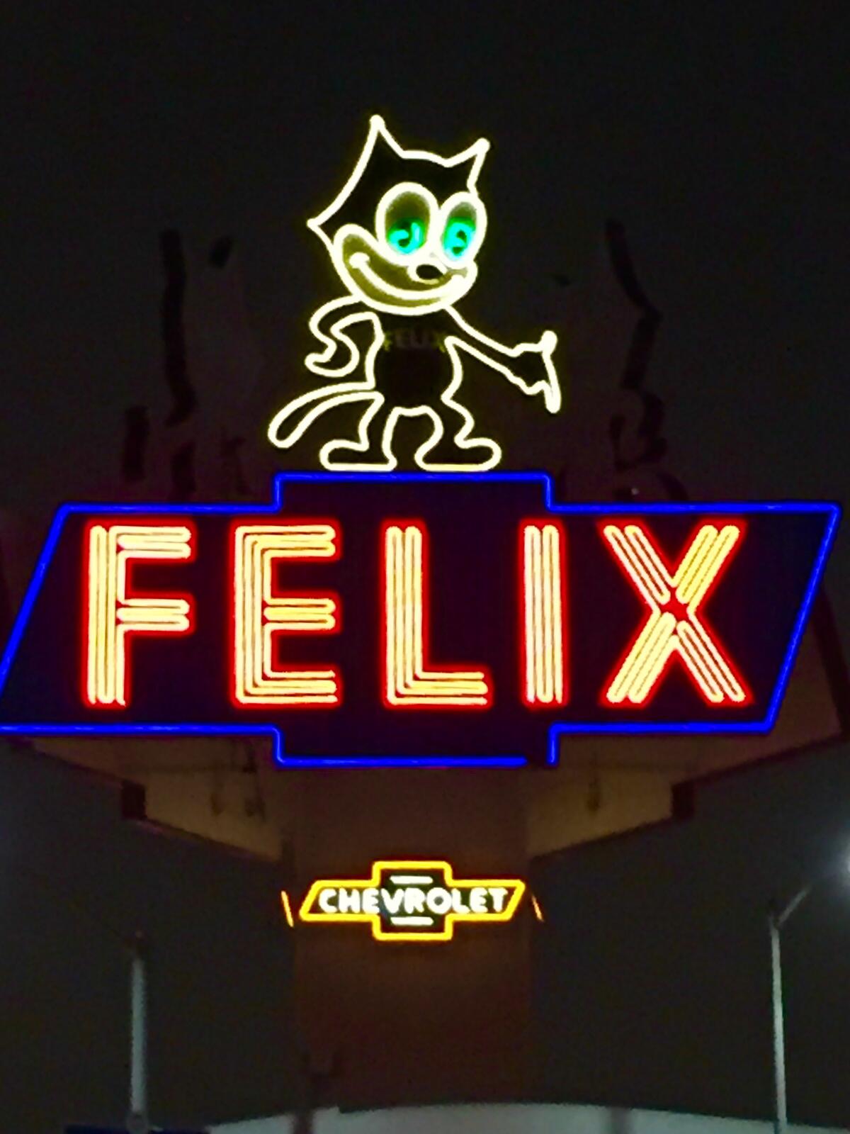 A neon sign featuring a cartoon cat with green eyes and the word FELIX