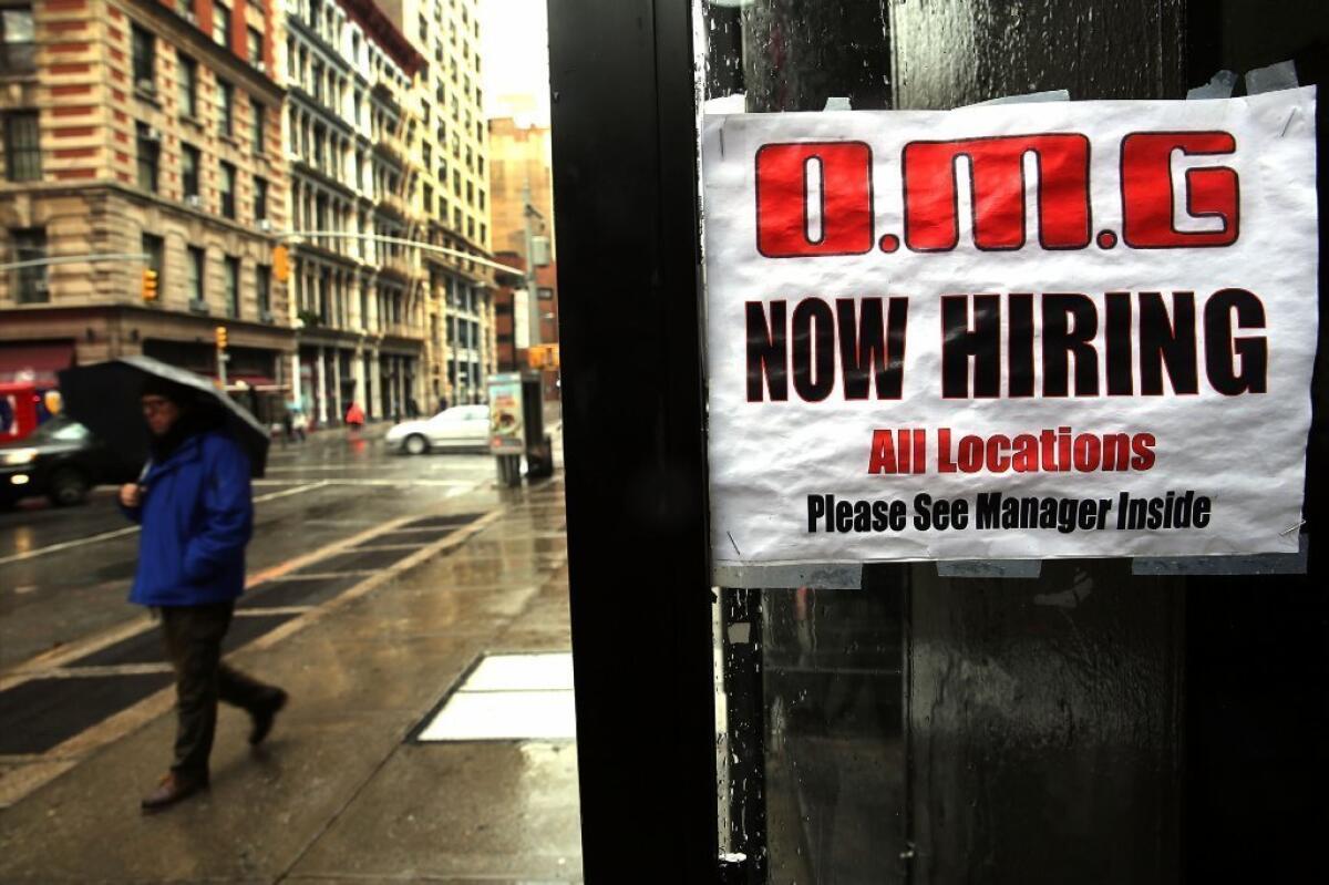 A sign in a window at a New York City retail store advertises for a job opening last month.