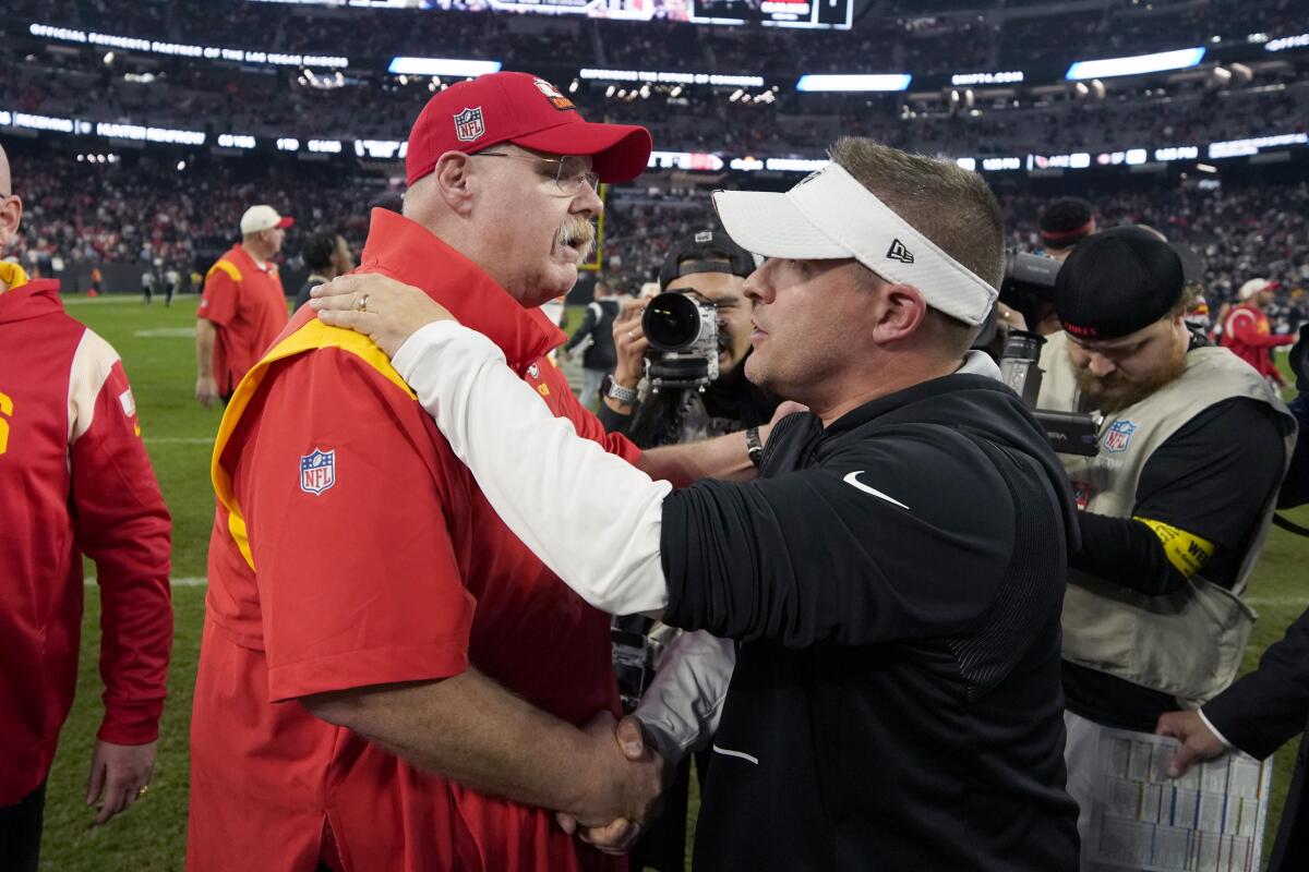 Chiefs coach Andy Reid, left, and Raiders coach Josh McDaniels shake hands after the game Jan. 7, 2023.
