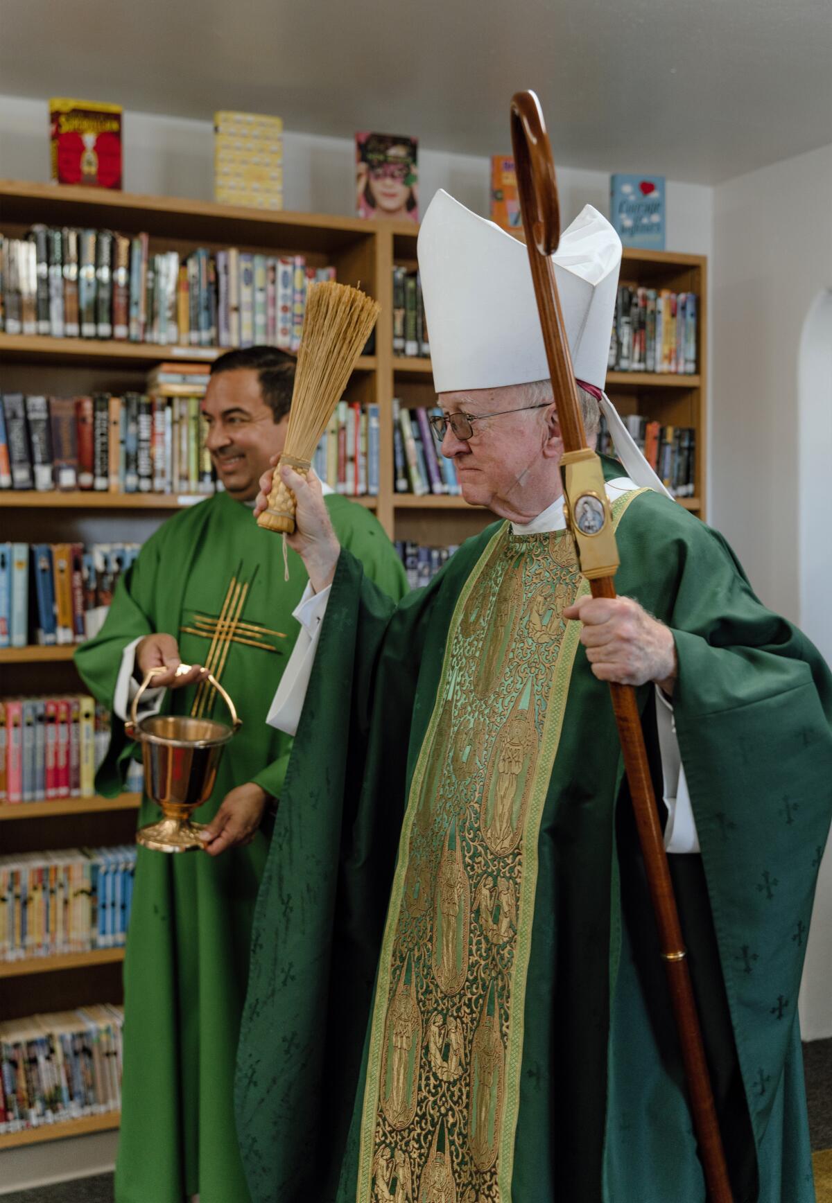 Bishop Kevin Vann, of the Diocese of Orange, blesses a new library at Saint Joachim School.