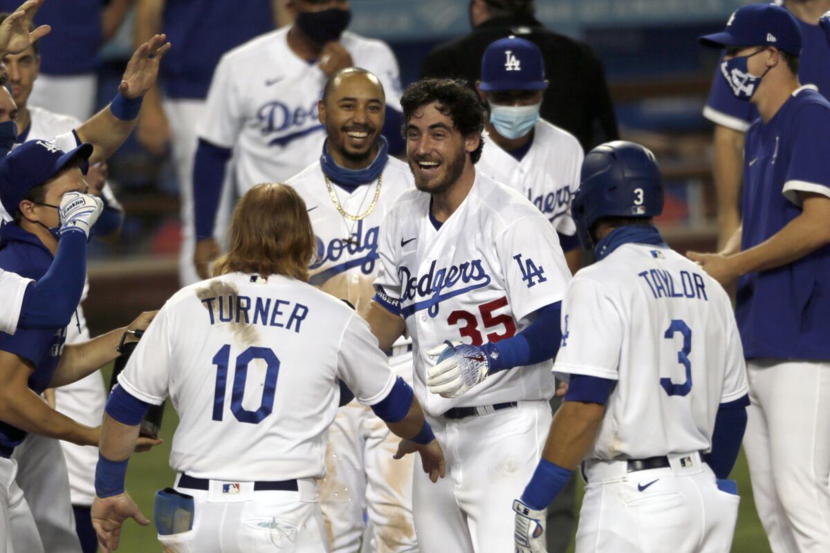 The Dodgers' Cody Bellinger, center, celebrates his game-winning home run with teammates.