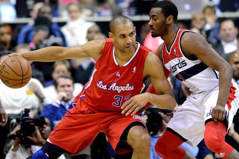 Clippers forward Grant Hill, working against Washington Wizards point guard John Wall during a game last season, announced his retirement after playing 18 NBA seasons.