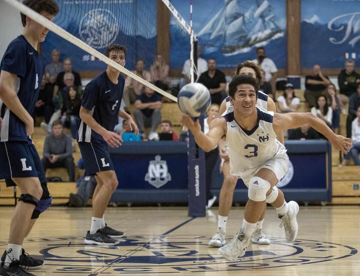 Newport Harbor's Joe Karlous dives for a ball at the net during the CIF State Southern California Regional Division I semifinal playoff match against Los Angeles Loyola in Newport Beach on Thursday.