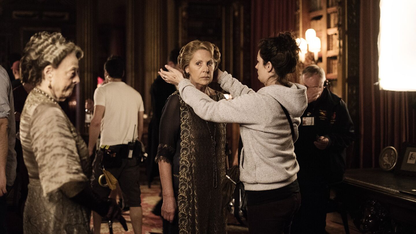 Penelope Wilton has final touches made to makeup by a crew member as Maggie Smith waits before filming a scene of "Downton Abbey" in the upstairs set at Highclere Castle.