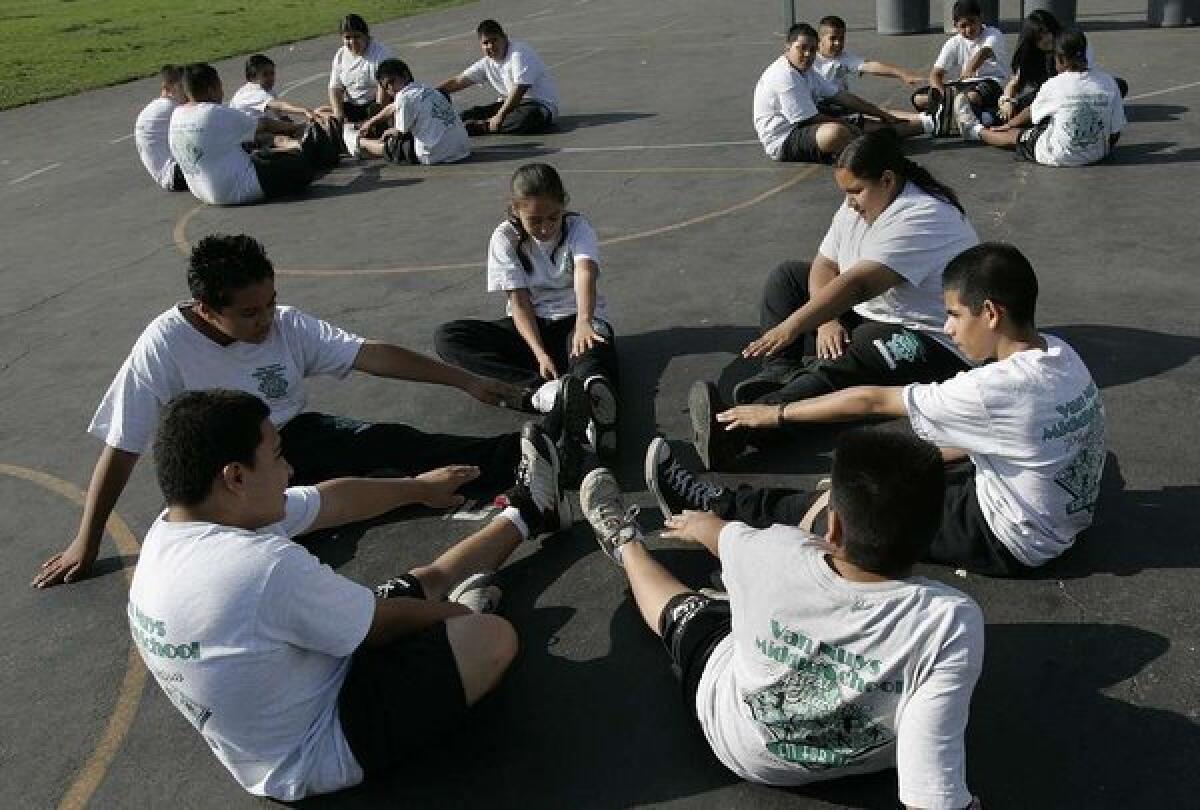Sixth-graders stretch at Van Nuys Middle School in gym class. In a new report, the Institute of Medicine urges programs to give kids more and better exercise -- in and out of school.
