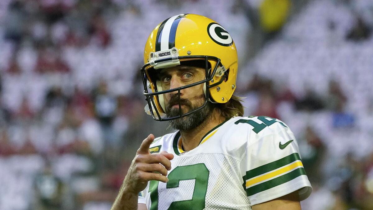 Green Bay Packers quarterback Aaron Rodgers points with his finger as he warms up prior to an NFL football game