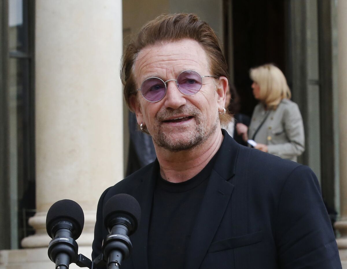 FILE - U2 singer Bono speaks to the media after a meeting at the Elysee Palace, in Paris, France on July 24, 2017. Bono's memoir "Surrender" planned for release on Nov. 1. (AP Photo/Michel Euler, File)