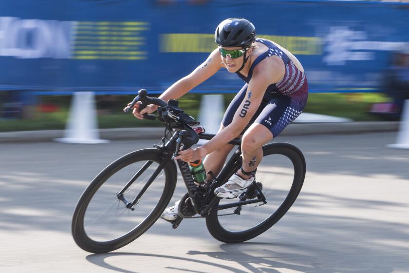 FILE - Taylor Knibb, of the United States, rides in the women's elite category of the ITU World Triathlon Series in Edmonton, Alberta, Friday, July 27, 2018. Knibb, an Olympic triathlete, won the women's time trial at the U.S. road cycling championships Wednesday, May 15, 2024, securing her spot on the American team and presenting her with a chance to compete in two different sports at the Paris Games. (Jason Franson/The Canadian Press via AP, File)