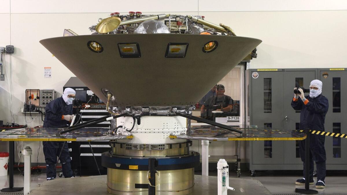 Personnel inspect NASA's Mars InSight lander before its launch from Vandenberg Air Force Base.