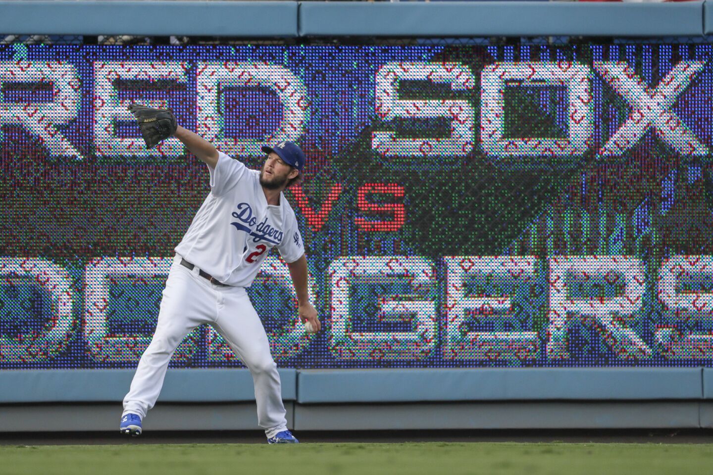 Dodgers ace Clayton Kershaw warms up in the outfield before facing the Red Sox in Game 5 of the World Series.