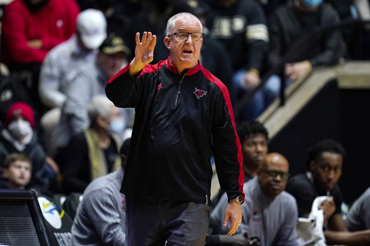 FILE - Omaha head coach Derrin Hansen gestures during the first half of an NCAA college basketball game against Purdue in West Lafayette, Ind., Friday, Nov. 26, 2021. On Sunday, March 6, 2022, Hansen, who coached Omaha during its transition from Division II to Division I, was fired after a second straight five-win season. (AP Photo/Michael Conroy, File)