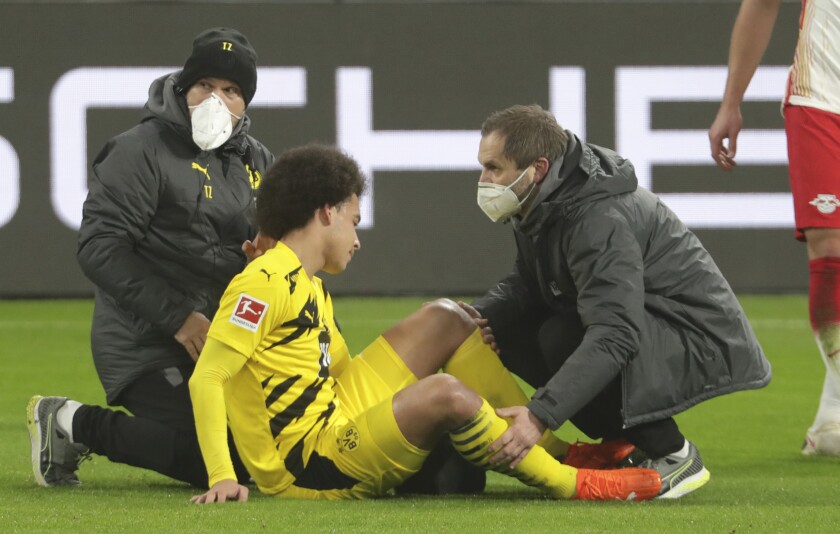 Dortmund's Axel Witsel receives medical attention during the German Bundesliga soccer match between RB Leipzig and Borussia Dortmund in Leipzig, Germany, Saturday, Jan. 9, 2021. (AP Photo/Michael Sohn)