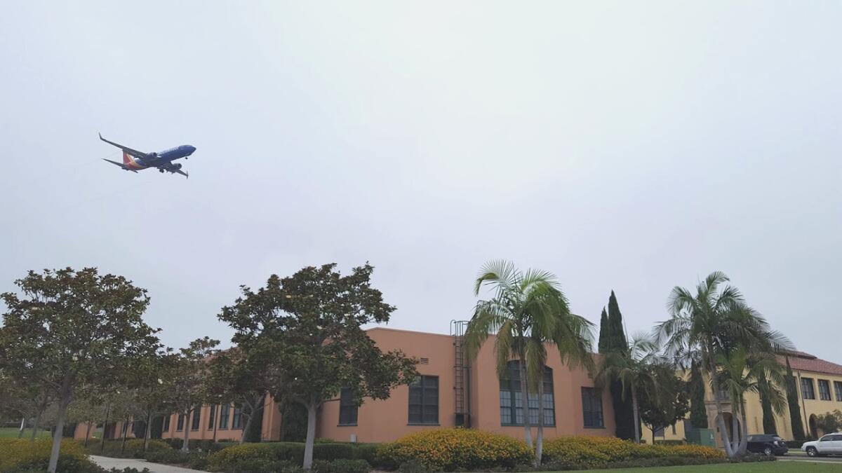 A plane flies low over Liberty Station in Point Loma.