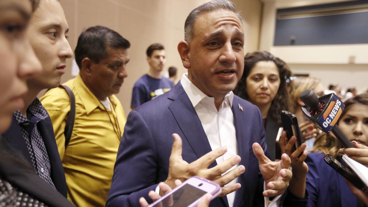 Democratic congressional candidate Gil Cisneros speaks with reporters at Cal State Fullerton. Cisneros is a former Republican running as a Democrat for an open Orange County seat.
