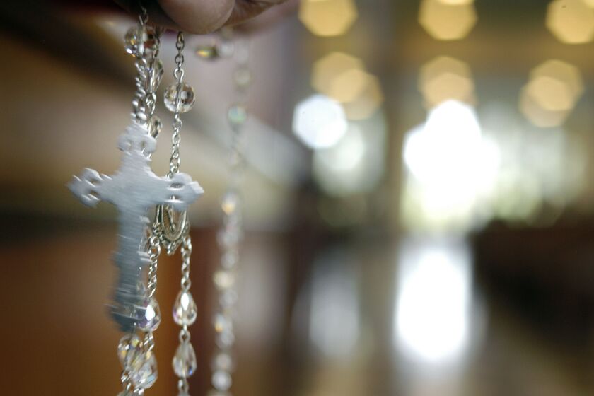 DOYLESTOWN, PA - APRIL 2: A woman holds Rosary beads as she prays for Pope John Paul II during a mass at the National Shrine to Czestochowa April 2, 2005 in Doylestown, Pennsylvania. Pope John Paul II visited Czestochowa in September of 1969 when he was a Cardinal. The Pope died today at the age of 84. (Photo by William Thomas Cain/Getty Images)