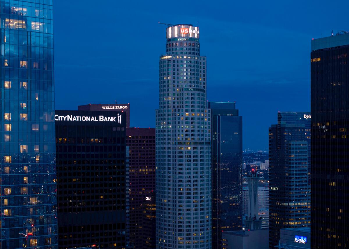 An aerial view of downtown Los Angeles illuminated by a sunset.