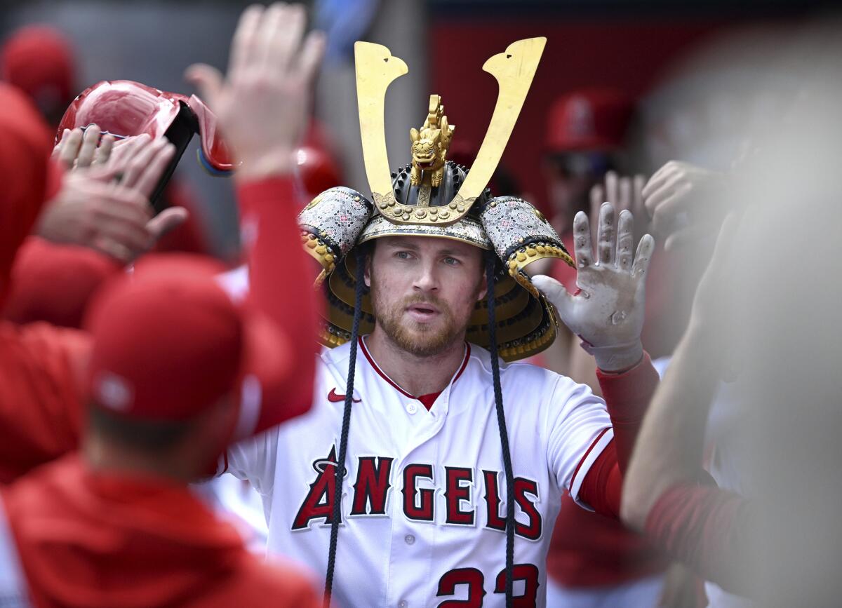 The Angels' Brandon Drury is congratulated after his home run against the Oakland Athletics Sunday.