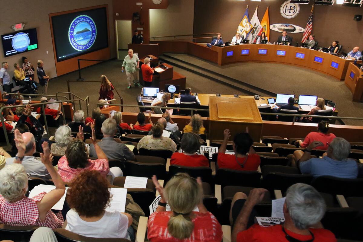 The Huntington Beach City Council listens to public comments during the meeting on Aug. 1.