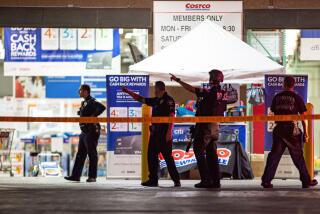 Police officers exit the Corona Costco following a shooting inside the wholesale warehouse store on June 14.