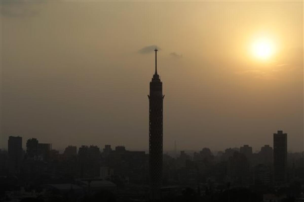 The sunset over Cairo, Egypt, with the Cairo Tower at center, Tuesday, Feb. 1, 2011. More than a quarter-million people flooded into the heart of Cairo Tuesday, filling the city's main square in by far the largest demonstration in a week of unceasing demands for President Hosni Mubarak to leave after nearly 30 years in power. (AP Photo/Lefteris Pitarakis)