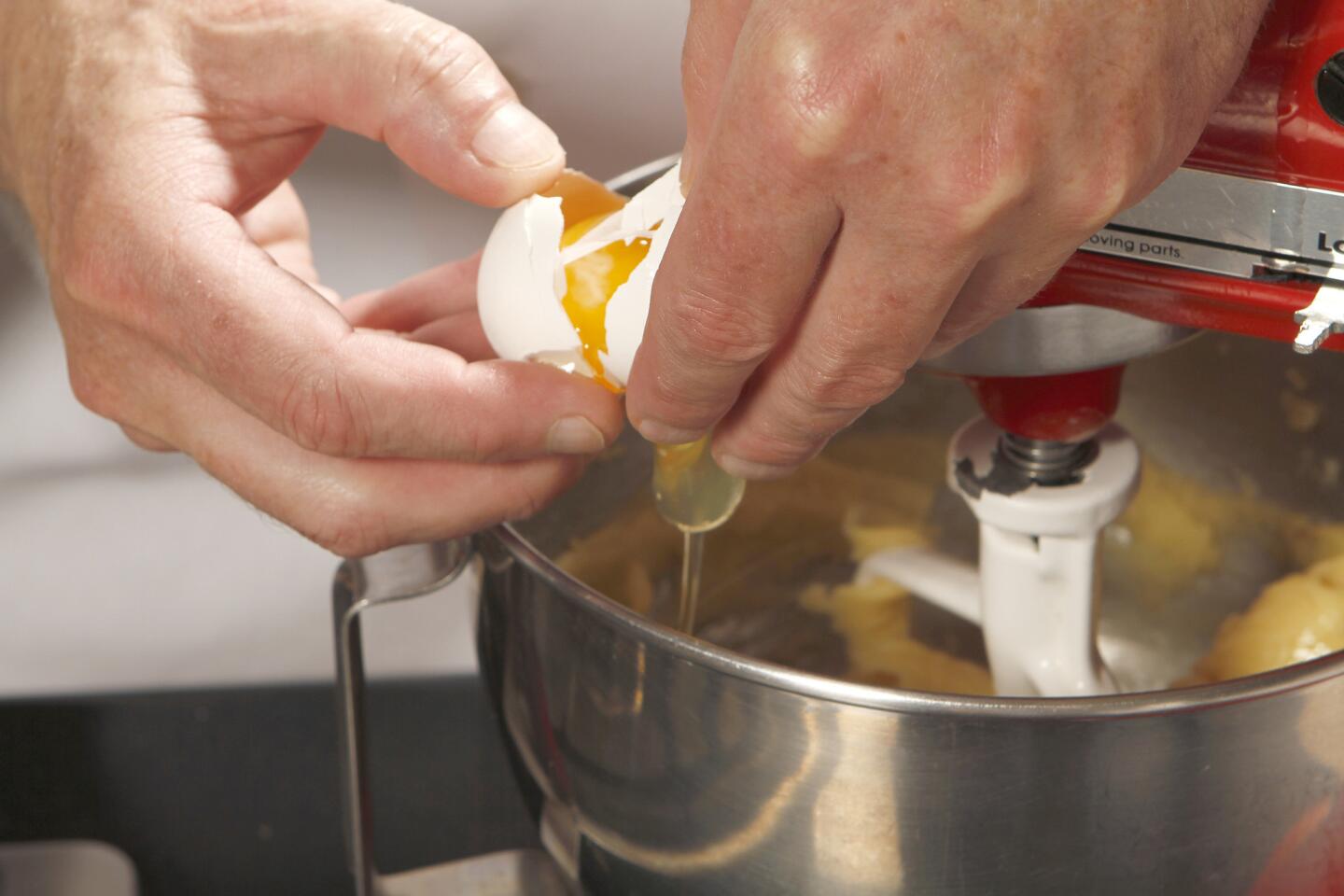 Beat the eggs into the warm mixture.