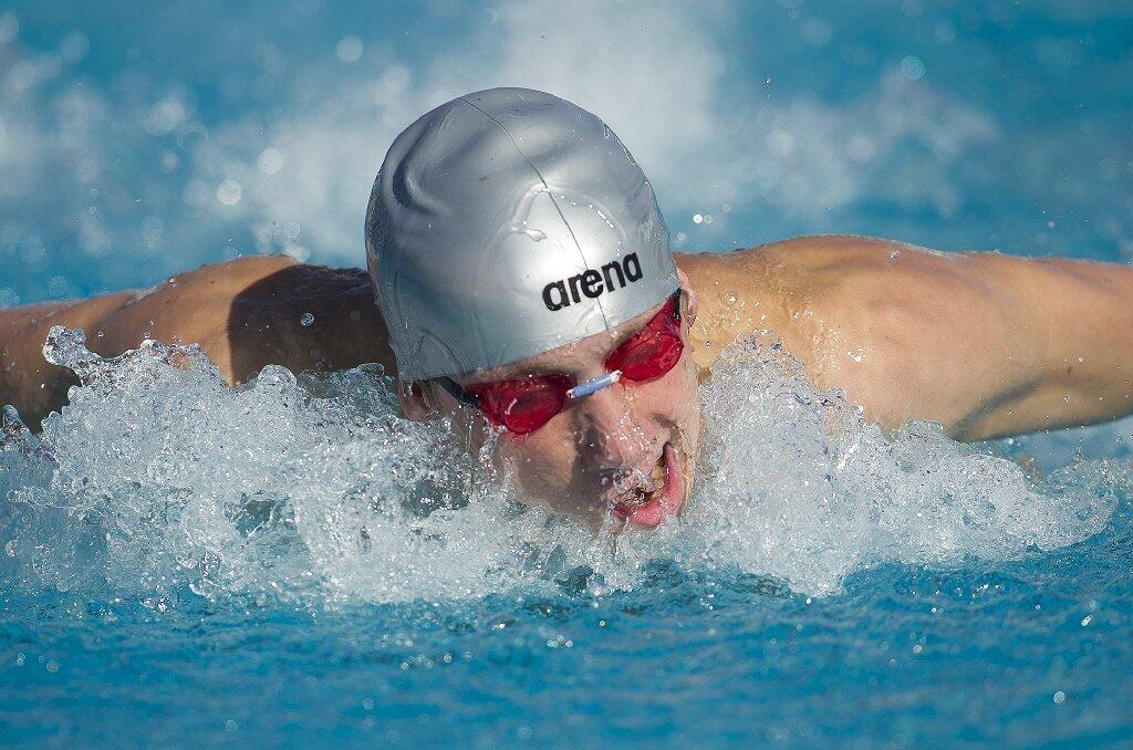 Corona del Mar's Ethan Archer competes in the 100 yard butterfly during a Pacific Coast League meet against Irvine at Woollett Aquatic Center on Wednesday..