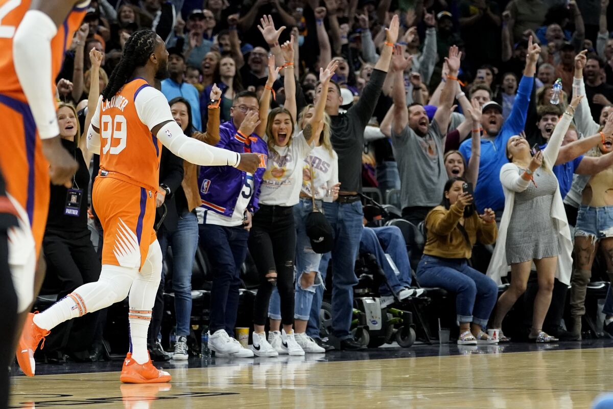 Phoenix Suns forward Jae Crowder (99) celebrates a three pointer against the New York Knicks during the second half of an NBA basketball game, Friday, March 4, 2022, in Phoenix. The Phoenix Suns defeated the Knicks 115-114. (AP Photo/Matt York)