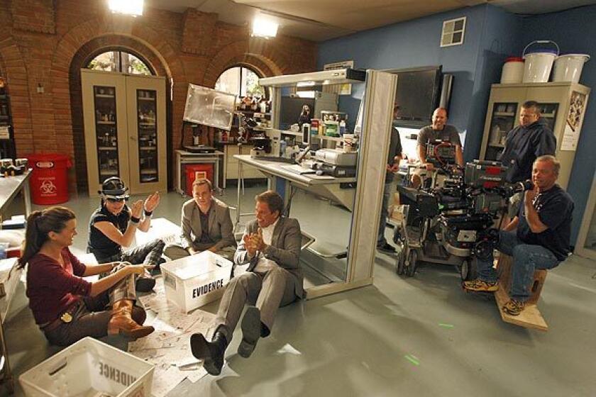 Cote de Pablo (Ziva), left, Pauley Perrette (Abby), Sean Murray (Timothy) and Michael Weatherly (DiNozzo) take a break after filming a recent scene on "NCIS" at the CBS series' sound stages at Valencia.